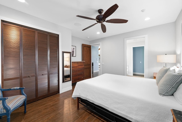 bedroom featuring dark wood-type flooring, a closet, and ceiling fan