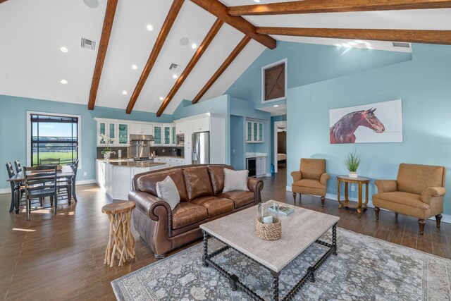 living room with dark hardwood / wood-style flooring, beam ceiling, and high vaulted ceiling