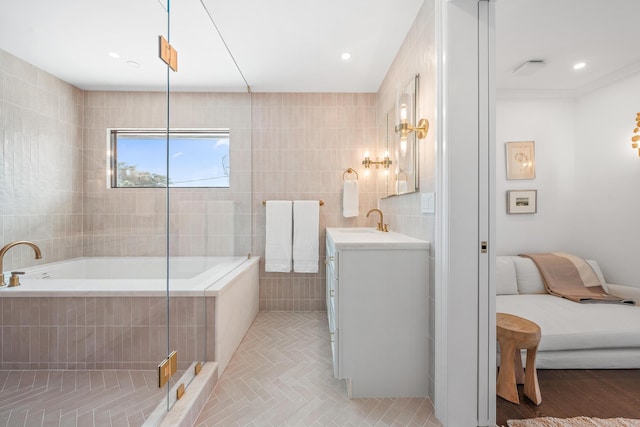 bathroom with tile patterned flooring, vanity, separate shower and tub, and tile walls