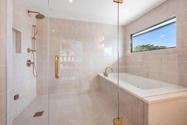 bathroom with independent shower and bath and tile walls