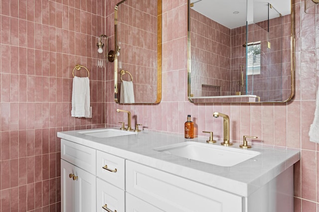 bathroom featuring vanity and tile walls