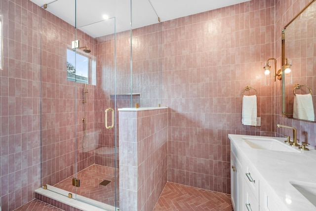 bathroom featuring vanity, tile walls, and walk in shower