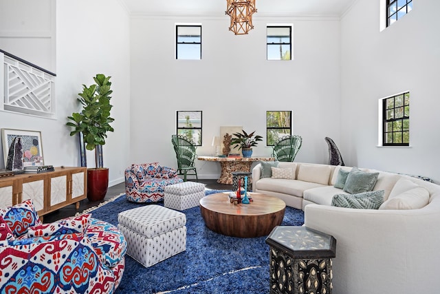 living room featuring crown molding, a high ceiling, and hardwood / wood-style flooring