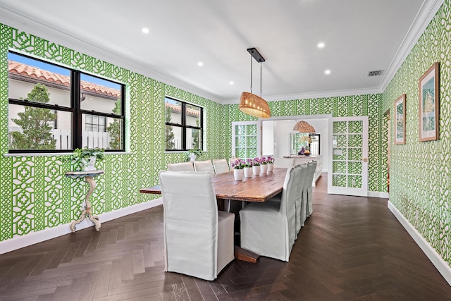 dining space with dark parquet floors and ornamental molding