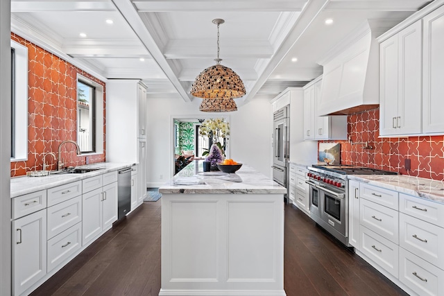 kitchen with white cabinetry, high end appliances, custom range hood, a kitchen island, and decorative light fixtures