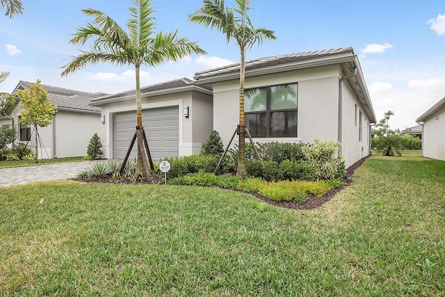 ranch-style home with a tile roof, a front yard, stucco siding, decorative driveway, and a garage