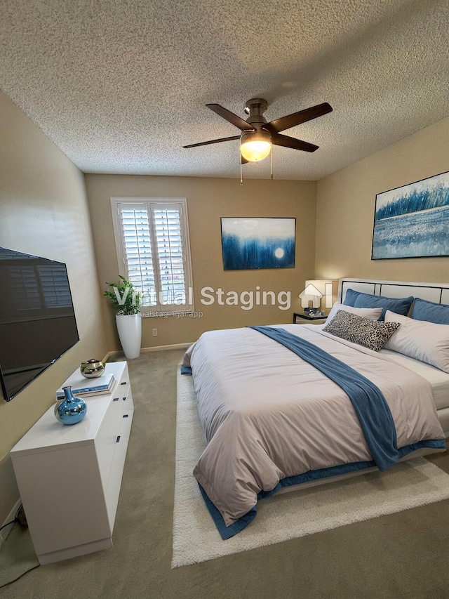 bedroom featuring ceiling fan, a textured ceiling, and carpet flooring