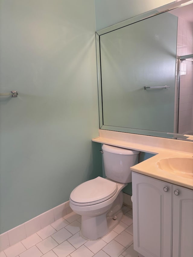 bathroom with toilet, tile patterned flooring, and vanity