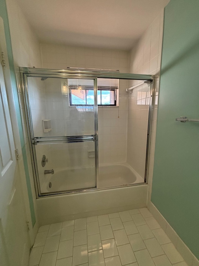 bathroom with enclosed tub / shower combo and tile patterned flooring