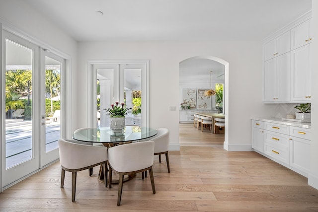 dining area with french doors and light wood-type flooring