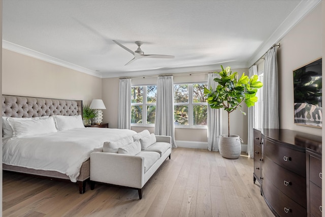 bedroom with crown molding, a textured ceiling, ceiling fan, and light hardwood / wood-style floors