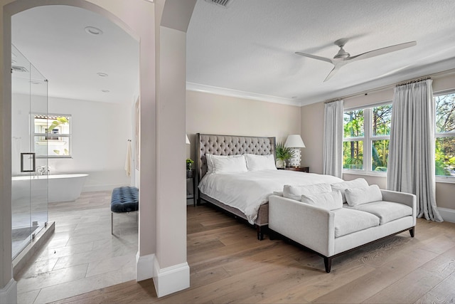 bedroom with multiple windows, hardwood / wood-style floors, and ceiling fan