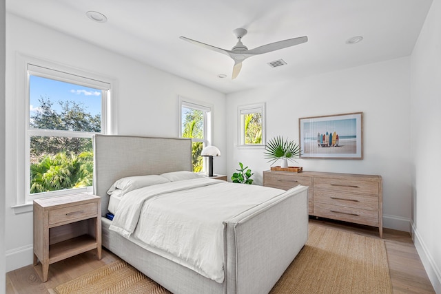 bedroom with ceiling fan and light hardwood / wood-style floors