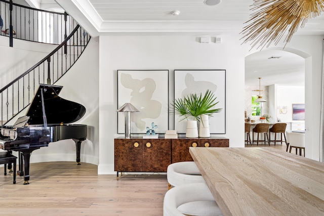 interior space with hardwood / wood-style flooring and crown molding