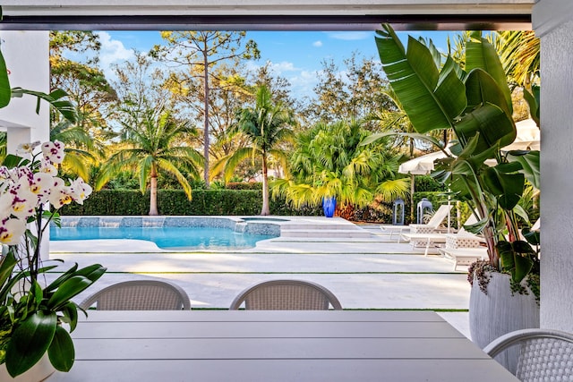 view of pool with a patio and an in ground hot tub