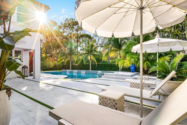 view of pool featuring an in ground hot tub and a patio area