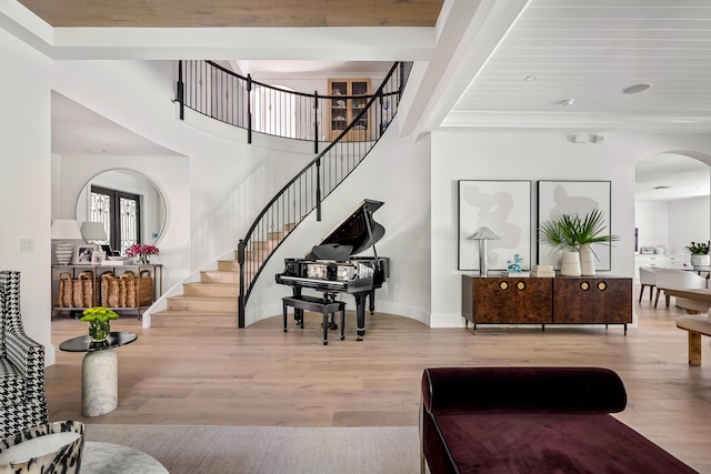 interior space with wood-type flooring and a towering ceiling