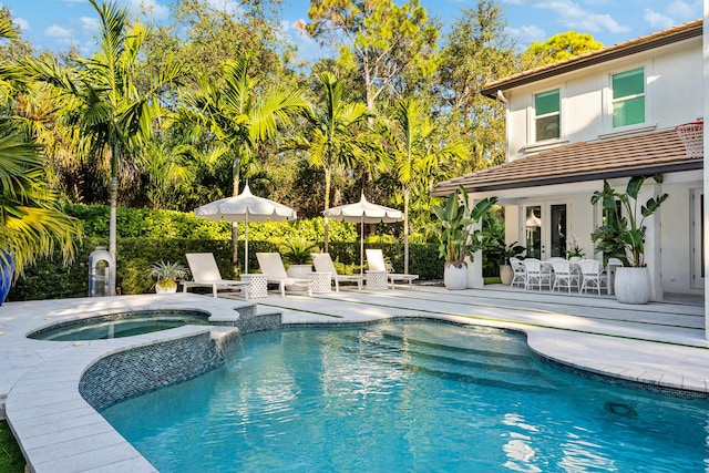 view of pool featuring a patio area, french doors, and an in ground hot tub