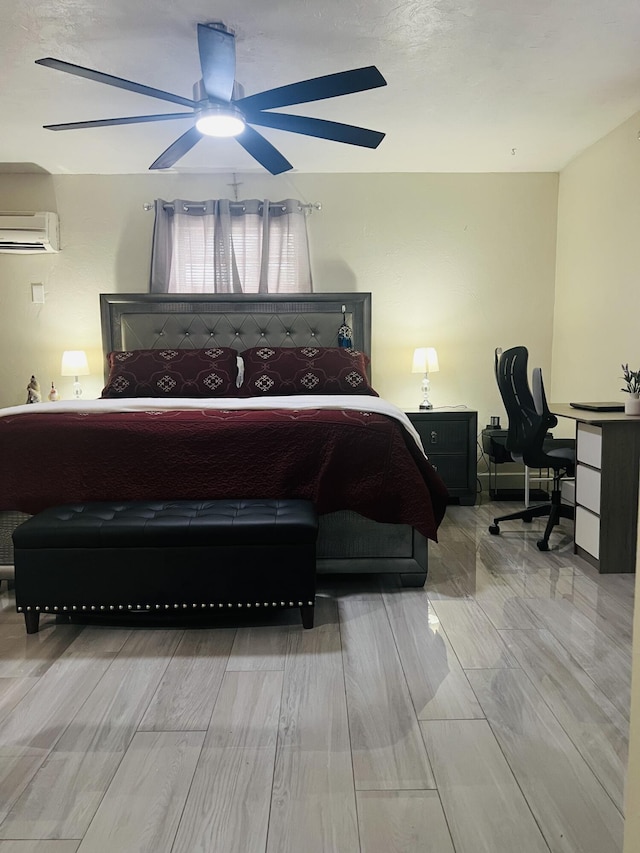 bedroom with ceiling fan and a wall unit AC