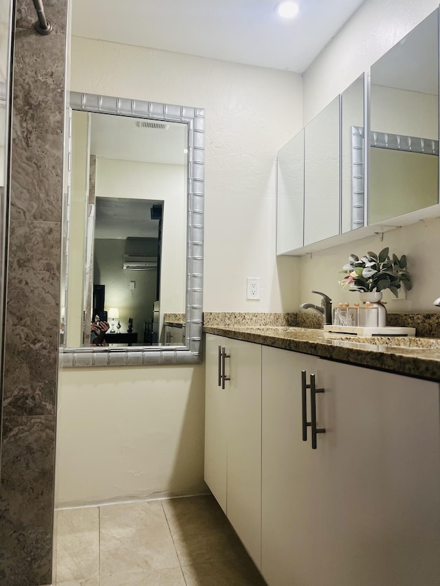 bathroom featuring tile patterned flooring and vanity