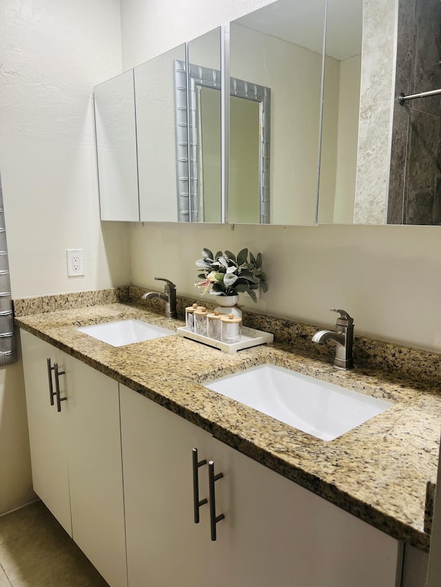 bathroom featuring tile patterned flooring and vanity