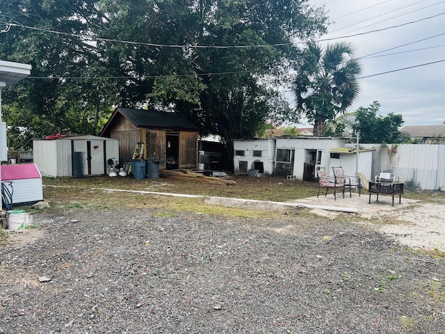 view of front of house featuring a patio area and a storage shed