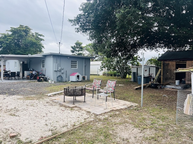 view of yard featuring a patio area and a storage unit