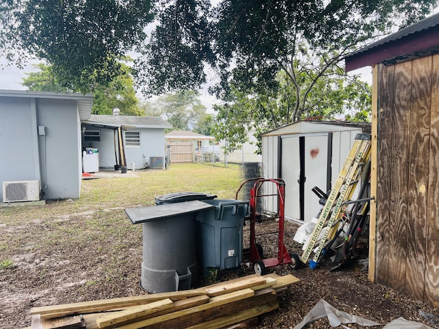 view of yard featuring cooling unit and a storage unit