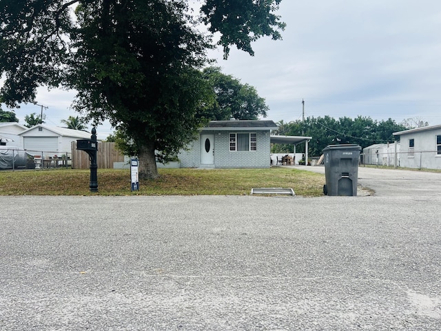 view of front of property featuring a carport