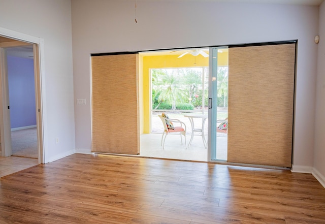 doorway to outside with ceiling fan, baseboards, and wood finished floors