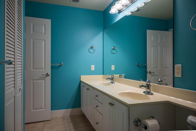 full bath featuring a closet, tile patterned flooring, and a sink