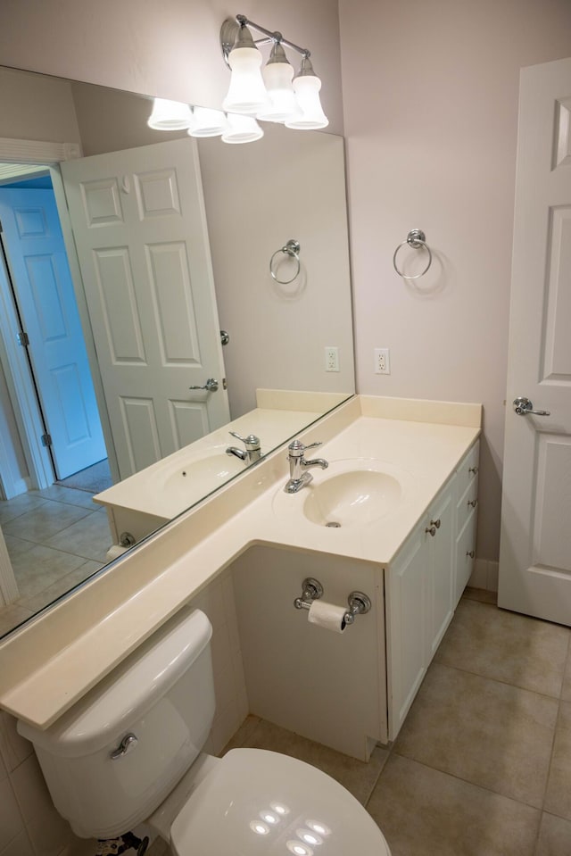 bathroom featuring toilet, tile patterned flooring, and vanity