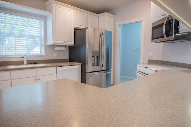 kitchen featuring white cabinetry, appliances with stainless steel finishes, and a sink