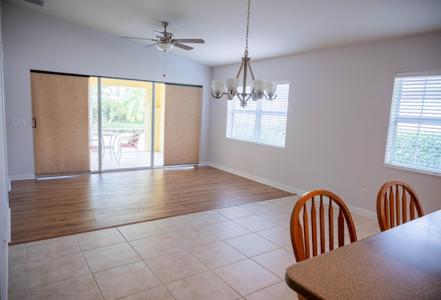 dining space with light tile patterned floors, lofted ceiling, and a wealth of natural light