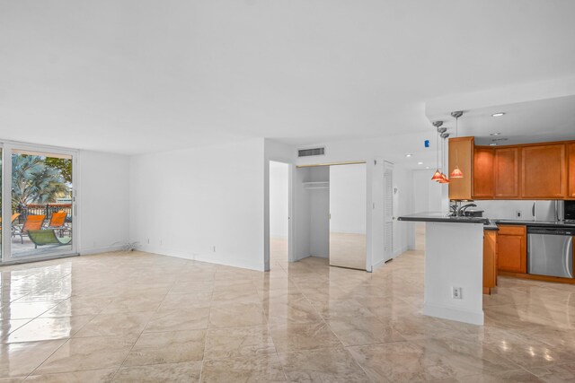 kitchen featuring pendant lighting, stainless steel dishwasher, and kitchen peninsula