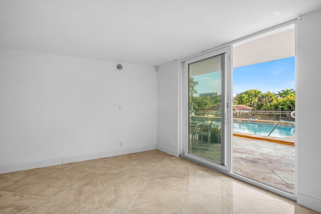 unfurnished room with expansive windows