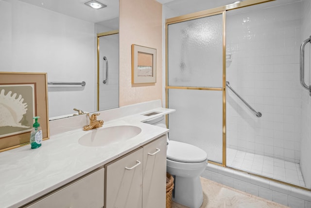 bathroom with vanity, walk in shower, and toilet