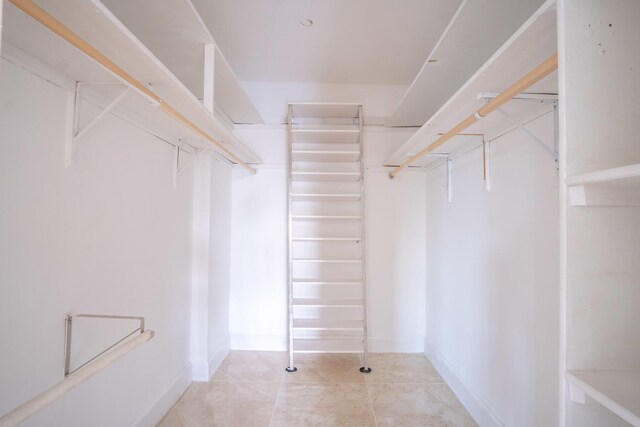 spacious closet with light tile patterned flooring