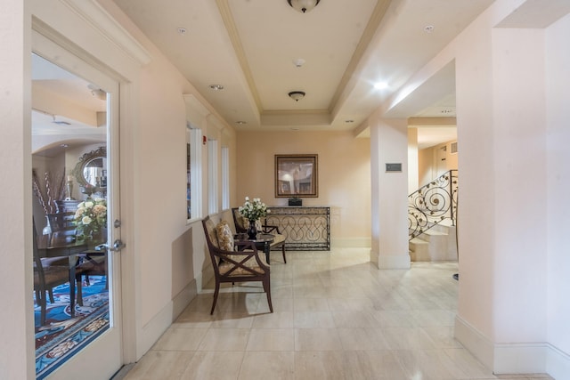 corridor featuring a raised ceiling