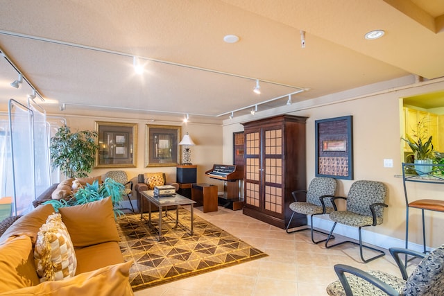 tiled living room featuring french doors, rail lighting, and a textured ceiling