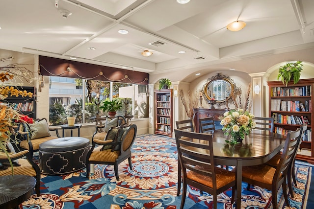 dining space with decorative columns, coffered ceiling, and beam ceiling