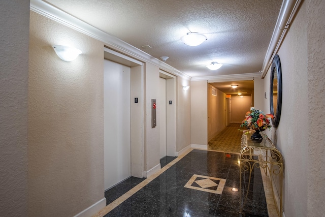 hallway with elevator, ornamental molding, and a textured ceiling