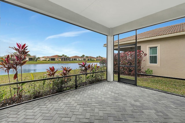 unfurnished sunroom with a water view