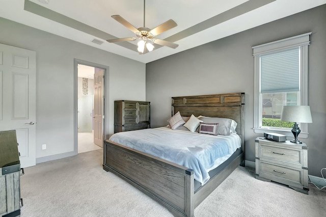 carpeted bedroom featuring ceiling fan and ensuite bath