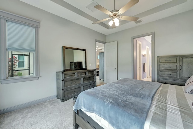 carpeted bedroom featuring ceiling fan and ensuite bath