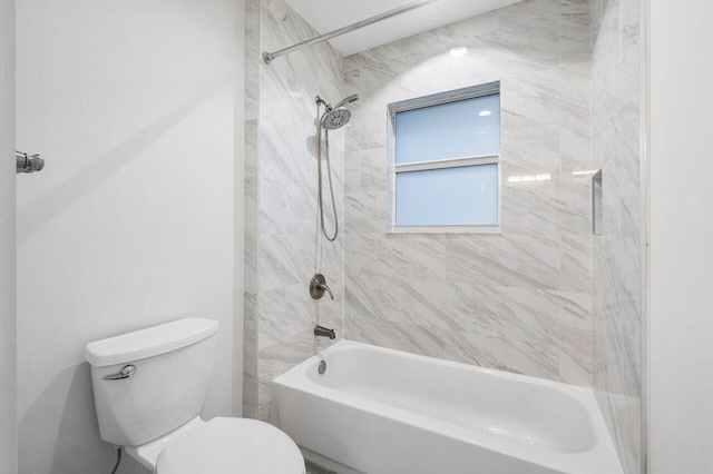 bathroom with toilet and tiled shower / bath combo