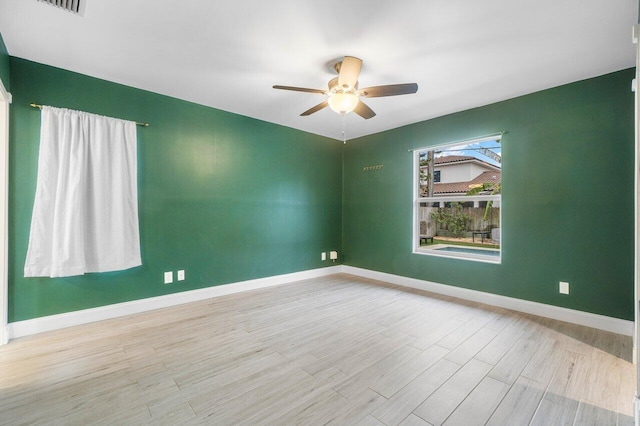 spare room with ceiling fan and light hardwood / wood-style floors