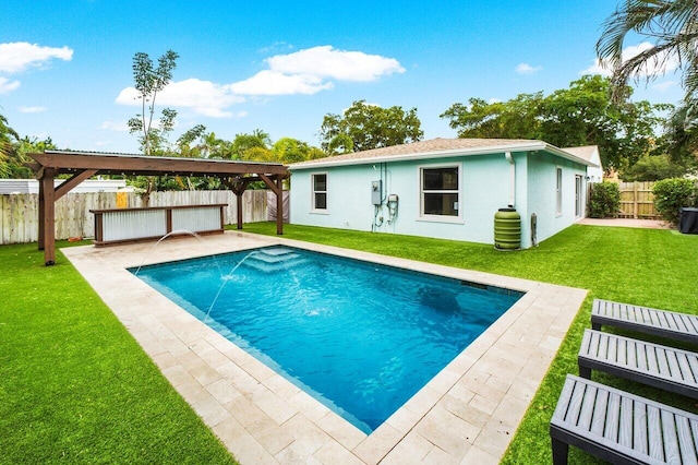 view of pool with pool water feature, a lawn, and a patio area