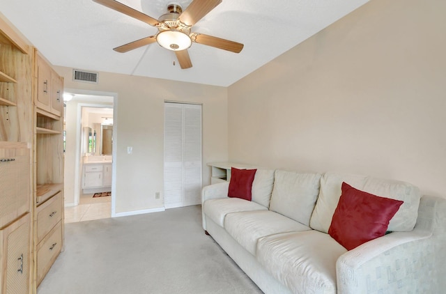 carpeted living room featuring ceiling fan