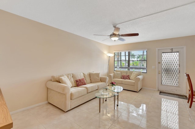 tiled living room featuring a textured ceiling and ceiling fan